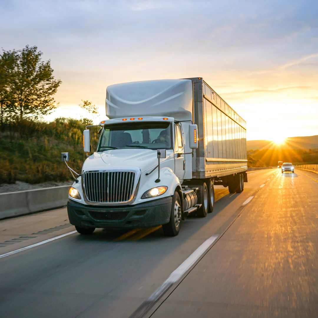 Semi truck on the highway at sunset